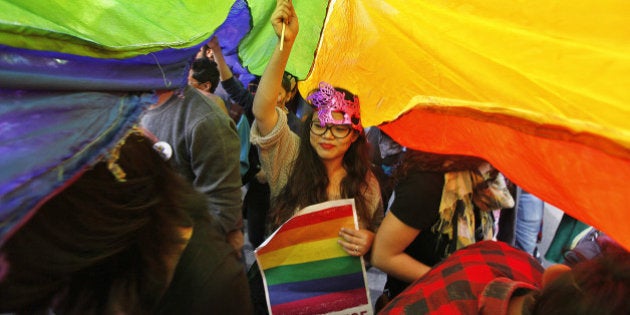 NEW DELHI, INDIA - NOVEMBER 29: A LGBT rights activist holds rainbow flag during Delhi Queer Pride March from Barakhamba Road to Jantar Mantar on November 29, 2015 in New Delhi, India. Organizers said that while the gay pride parade celebrated the gains India's LGBT community has made in recent years, they also wanted to highlight the continuing discrimination it faces. The Delhi Queer Pride Committee also demanded the repeal of Section 377 of the Indian Penal Code, which criminalizes homosexual acts. (Photo by Raj K Raj/Hindustan Times via Getty Images)