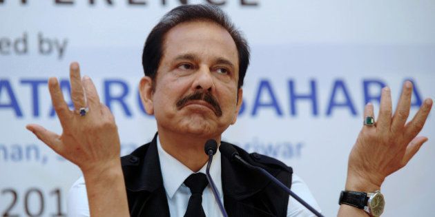 Chairman of India's Sahara Group Subrata Roy gestures as he addresses a press conference in Kolkata on November 29, 2013. An Indian regulator froze the bank accounts of two companies of the giant Sahara group in February 2013, after it failed to obey a court order to repay billions of dollars illegally collected from investors. Sahara, a household name in India and sponsor of the national cricket team, raised 240 billion rupees ($4.4 billion) in illegal bond sales to 30 million small investors between 2008 and 2011. AFP PHOTO/Dibyangshu SARKAR (Photo credit should read DIBYANGSHU SARKAR/AFP/Getty Images)
