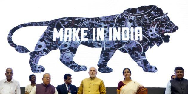 Indian Prime Minister Narendra Modi, center, unveils the logo of 'Make in India' initiative in New Delhi, India, Thursday, Sept. 25, 2014. Scores of business leaders from India and abroad attended the launch of the initiative where in the Indian Prime Minister called on manufacturers across the globe to come and make India a manufacturing hub. (AP Photo/Saurabh Das)