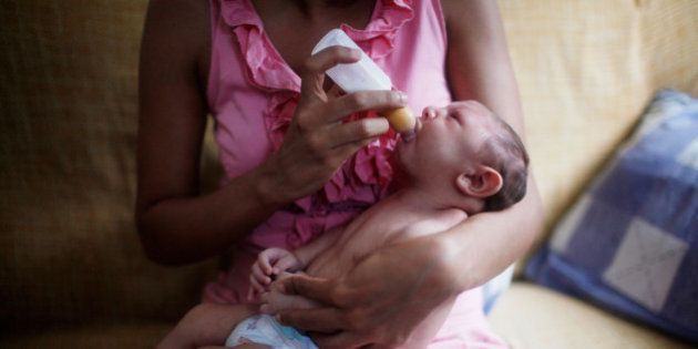RECIFE, BRAZIL - FEBRUARY 03: Mother Daniele Santos feeds her baby Juan Pedro, 2-months-old, in their living room on February 3, 2016 in Recife, Pernambuco state, Brazil. In the last four months, authorities have recorded thousands of cases in Brazil in which the mosquito-borne Zika virus may have led to microcephaly in infants. Microcephaly results in an abnormally small head in newborns and is associated with various disorders. The state with the most cases is Pernambuco, whose capital is Recife, and is being called the epicenter of the outbreak. (Photo by Mario Tama/Getty Images)