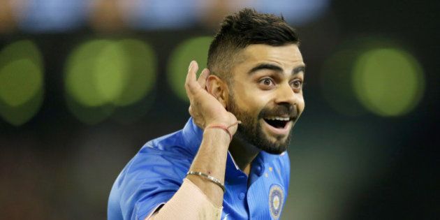 MELBOURNE, AUSTRALIA - JANUARY 29: Virat Kohli of India gestures to Australian fans after India took the wicket of Glenn Maxwell of Australia during the International Twenty20 match between Australia and India at Melbourne Cricket Ground on January 29, 2016 in Melbourne, Australia. (Photo by Darrian Traynor - CA/Cricket Australia/Getty Images)