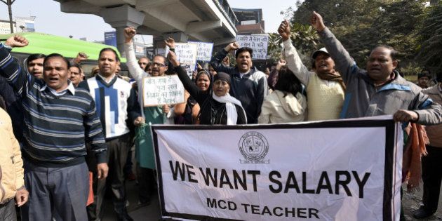 NEW DELHI, INDIA - FEBRUARY 3: Delhi MCD sanitation employees and MCD teachers shout slogans against the Delhi Government and Central Government from Nirman Vihar Metro Station to ITO near Delhi Secretariat for not being paid their salaries for the last three months, on February 3, 2016 in New Delhi, India. The agitating MCD staffs on Wednesday refused to call off their strike even as the mayors of the north and east Delhi municipal corporations said that they will accept the loan extended by the AAP government as a grant only. (Photo by Sonu Mehta/Hindustan Times via Getty Images)