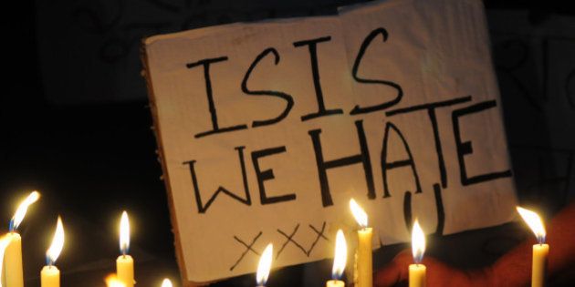 BHOPAL, INDIA - NOVEMBER 15: A Muslim kid holds a placard with slogan against the ISIS during a candle light vigil to express solidarity with the victims of Paris terror attacks on November 15, 2015 in Bhopal, India. At least 129 people lost their lives in terror attacks by terrorists in Paris at the packed Bataclan concert hall, restaurants and bars, and outside the Stade de France national stadium. The Islamist jihadist group IS, that has seized control of large parts of Syria and Iraq, claimed responsibility for the attacks. (Photo by Mujeeb Faruqui/Hindustan Times via Getty Images)