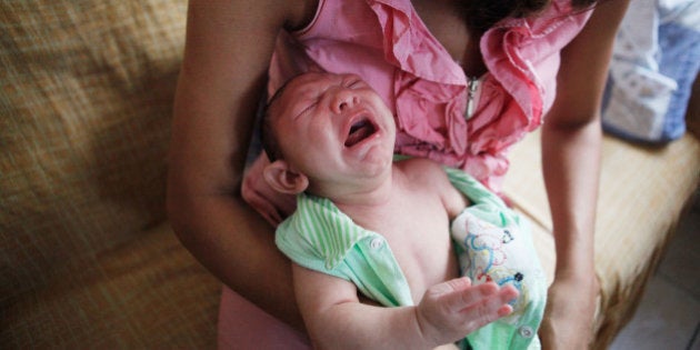 RECIFE, BRAZIL - FEBRUARY 03: Mother Daniele Santos changes her baby Juan Pedro, 2-months-old, who was born with microcephaly, on February 3, 2016 in Recife, Pernambuco state, Brazil. In the last four months, authorities have recorded thousands of cases in Brazil in which the mosquito-borne Zika virus may have led to microcephaly in infants. Microcephaly results in an abnormally small head in newborns and is associated with various disorders. The state with the most cases is Pernambuco, whose capital is Recife, and is being called the epicenter of the outbreak. (Photo by Mario Tama/Getty Images)