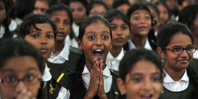 Indian schoolchildren react after watching a tiger on a giant screen during a 'Kids for Tigers' programme on the eve of World Tiger Day at Hyderabad Public School in Hyderabad on July 28, 2015. World Tiger Day, is an annual celebration to raise awareness aimed at educating children about tiger conservation, held annually on July 29. AFP PHOTO/NOAH SEELAM / AFP / NOAH SEELAM (Photo credit should read NOAH SEELAM/AFP/Getty Images)