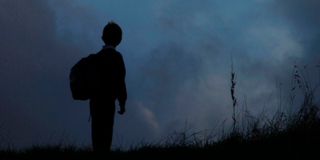 Young Boy Returning Home From School. Boots Hanging From Telegraph Wires. (Photo by: Universal Education/Universal Images Group via Getty Images)