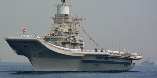 Indian Navy personnel stand on the INS Vikramaditya, a modified Kiev-class aircraft carrier, during the International Fleet Review in Visakhapatnam on February 6, 2016. India kicked off a major display of maritime might, with ships from 50 navies converging on the country's east coast, as New Delhi seeks to boost its leadership in the region. Ninety ships including from the US, French, British and Chinese navies are taking part in the international fleet review in the Bay of Bengal -- a ceremonial inspection and parade of boats and crews. AFP PHOTO / AFP / STR (Photo credit should read STR/AFP/Getty Images)