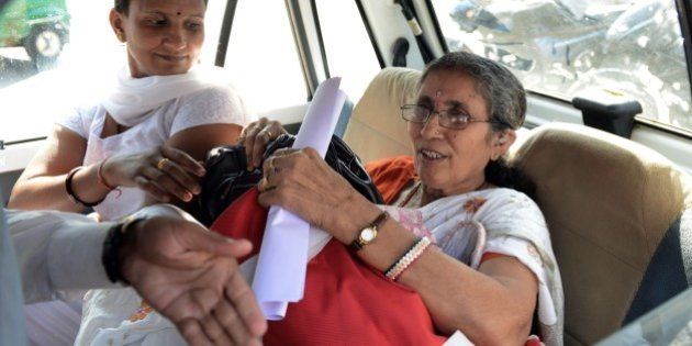 Indian Prime Minister Narendra Modi's wife, Jashodaben (R) holds a copy of the Right To Information (RTI) application filed by her as she leaves the Deputy Superintendent of Police (DSP) office in Mehsana, some 70 kms from Ahmedabad on November 24, 2014. An RTI application requesting an explanation of the sort of government security she receives, has been filed by retired school-teacher, Jashodaben. AFP PHOTO / Sam PANTHAKY (Photo credit should read SAM PANTHAKY/AFP/Getty Images)