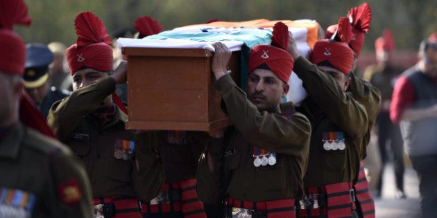 Indian soldiers carry a coffin with the body of avalanche survivor Hanumanthappa Koppad in New Delhi on February 11, 2016. Indian army soldier Koppad, who was rescued nearly a week after being buried in eight metres (25 feet) of snow by a deadly Himalayan avalanche, died in hospital on February 11 of his injuries, the army said. AFP PHOTO / AFP / STR (Photo credit should read STR/AFP/Getty Images)