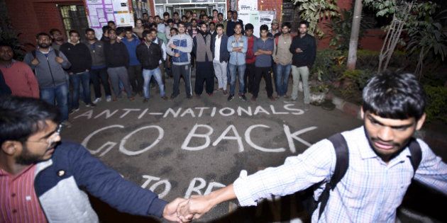 NEW DELHI, INDIA - FEBRUARY 12: ABVP Students protest against the organisers of the event on Afzal Guru where slogans were anti-national slogans were raised at JNU Campus on February 12, 2016 in New Delhi, India. JNU students union president Kanhaiya Kumar was arrested on in connection with a case of sedition and criminal conspiracy over holding of an event at the prestigious institute against hanging of Parliament attack convict Afzal Guru in 2013. A group of students on Tuesday held an event on the JNU campus and allegedly shouted slogans against India. (Photo by Arun Sharma/Hindustan Times via Getty Images)