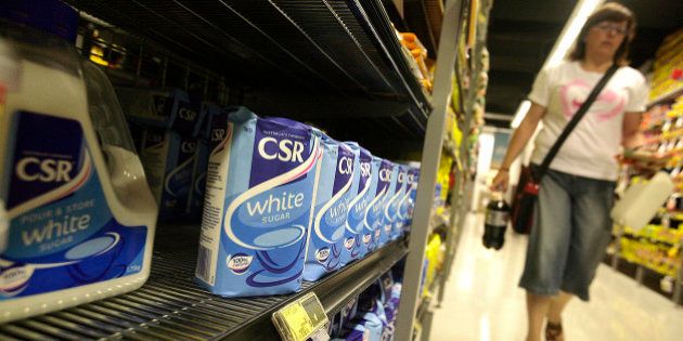 A customer walks past CSR Ltd. white sugar products on a shelf at a supermarket in Melbourne, Australia, on Tuesday, Jan. 12, 2010. Bright Food Group Co., the biggest food company in Shanghai, offered as much as A$1.5 billion ($1.4 billion) cash for CSR Ltd.'s sugar unit to gain raw materials after global prices more than doubled in the past year. Photographer: Luis Enrique Ascui/Bloomberg via Getty Images