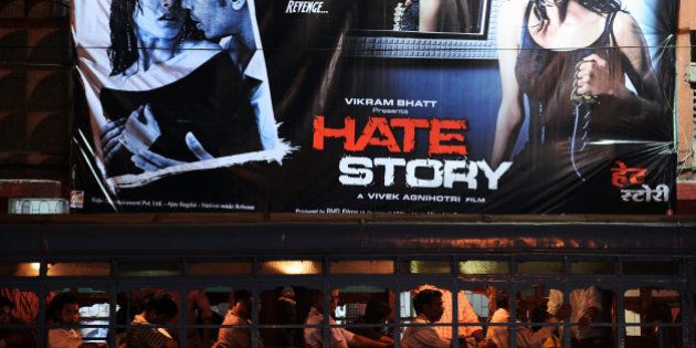 A passenger bus (bottom) drives past a banner for the film Hate Story hung outside a cinema hall in Kolkata on April 19, 2012. Two versions of promotional posters for the film 'Hate Story' are being painted blue in Kolkata following orders of the Calcutta High Court, to hide the bare back of Bengali actress Paoli Dam which were deemed 'obscene and provocative' by the West Bengal Board of Censorship, a report said. AFP PHOTO/Dibyangshu SARKAR (Photo credit should read DIBYANGSHU SARKAR/AFP/Getty Images)