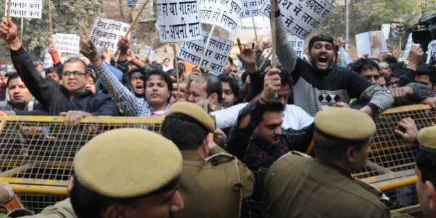 NEW DELHI, INDIA - FEBRUARY 12: Police trying to stop residents of nearby Munirka Village during demonstration against the organisers of the event on Afzal Guru where anti-national slogans were raised at JNU Campus on February 12, 2016 in New Delhi, India. JNU studentsâ Union President Kanhaiya Kumar was arrested on in connection with a case of sedition and criminal conspiracy over holding of an event at the prestigious institute against hanging of Parliament attack convict Afzal Guru in 2013. A group of students on Tuesday held an event on the JNU campus and allegedly shouted slogans against India. (Photo by Arun Sharma/Hindustan Times via Getty Images)