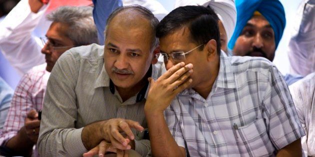 Delhi Chief Minister Arvind Kejriwal, right, speaks to his deputy Manish Sisodia at a farmerâs rally near the Indian parliament in New Delhi, India, Wednesday, April 22, 2015. Indian farmers and the opposition parties are protesting against a government plan to ease rules for obtaining land for industry and development projects. (AP Photo/Saurabh Das)