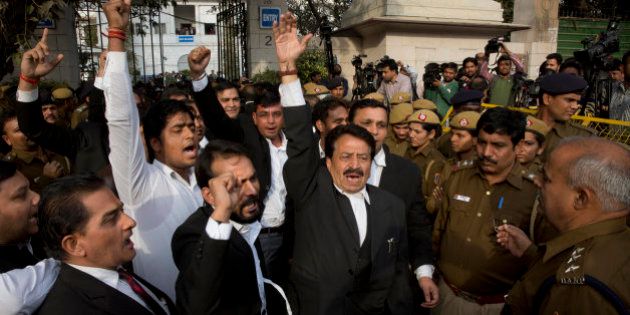 Lawyers shout slogans against Jawaharlal Nehru University student union president Kanhaiya Kumar outside a court where he was expected to be produced in New Delhi, India, Monday, Feb. 15, 2016. Kumar was arrested Friday on charges of sedition over a demonstration days earlier at the university to mark the anniversary of the 2013 execution of Afzal Guru, a Kashmiri man convicted of an attack on India's Parliament. (AP Photo/Manish Swarup)