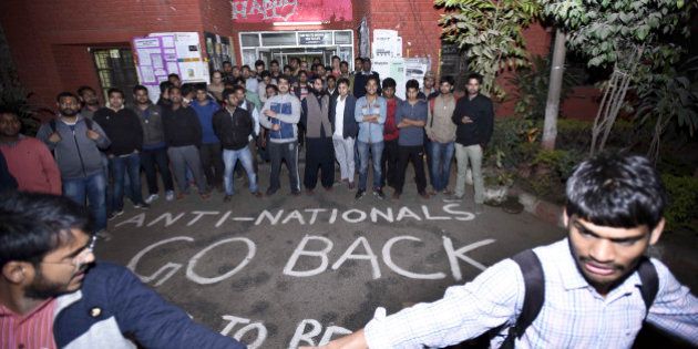NEW DELHI, INDIA - FEBRUARY 12: ABVP students protest against the organisers of the event on Afzal Guru where anti-national slogans were raised at JNU Campus on February 12, 2016 in New Delhi, India. JNU studentsâ Union President Kanhaiya Kumar was arrested on in connection with a case of sedition and criminal conspiracy over holding of an event at the prestigious institute against hanging of Parliament attack convict Afzal Guru in 2013. A group of students on Tuesday held an event on the JNU campus and allegedly shouted slogans against India. (Photo by Arun Sharma/Hindustan Times via Getty Images)