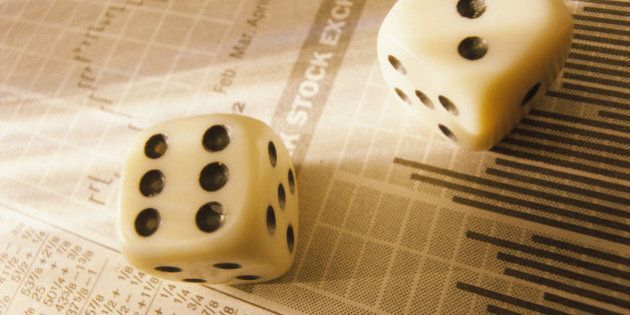 Dice on stock market report, close-up