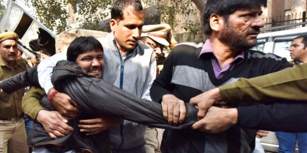 NEW DELHI, INDIA - FEBRUARY 17: JNU Students' Union President Kanhaiya Kumar being taken to Patiala House Court on February 17, 2016 in New Delhi, India. A bail hearing for JNUSU President Kanhaiya Kumar, who was arrested for sedition, descended into chaos on Wednesday as protesting lawyers chanting pro-government slogans barged into a courthouse compound. Delhi's Patiala House Court on Wednesday sent JNU student union leader Kanhaiya Kumar to judicial custody till March 2. JNU has been on the boil over the arrest of its student's Union President Kanhaiya Kumar on sedition charges after some students organised a meet to mark the anniversaries of executions of Parliament attack convict Afzal Guru. (Photo by Virender Singh Gosain/Hindustan Times via Getty Images)