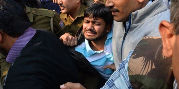 Indian student union leader Kanhaiya Kumar (C) is escorted by police into Patiala Court for a hearing in New Delhi on February 17, 2016. Student union leader Kanhaiya Kumar had been arrested for allegedly shouting anti-India slogans at a rally called to protest against a Kashmiri separatist's execution three years ago -- a charge he denies. His arrest has reignited a row over freedom of expression in India, where some rights campaigners say the Hindu nationalist government is using the British-era sedition law to clamp down on dissent. AFP PHOTO / CHANDAN KHANNA / AFP / Chandan Khanna (Photo credit should read CHANDAN KHANNA/AFP/Getty Images)