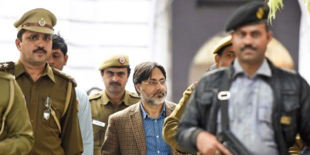 NEW DELHI, INDIA - FEBRUARY 16: Delhi Police officers arrest SAR Geelani (Syed Abdul Rahman Geelani), former Delhi University lecturer, in connection with the sedition charges for allegedly organising an event at the Press Club of India to mark Parliament attack convict Afzal Guru's death anniversary, at Parliament Street Police Station on February 16, 2016 in New Delhi, India. Geelani was detained by police on Monday evening. Geelani had faced trial as Guru's co-accused in the Parliament attack case but was acquitted by the Delhi High Court, a ruling that was later upheld by the Supreme Court. Mr. Geelani, who was acquitted in the 2001 Parliament attack case, was roughed up allegedly by ABVP members on the Jawaharlal Nehru University campus on Wednesday night. Mr. Geelani had arrived there to deliver a talk on Kashmir issues. (Photo by Sonu Mehta/Hindustan Times via Getty Images)