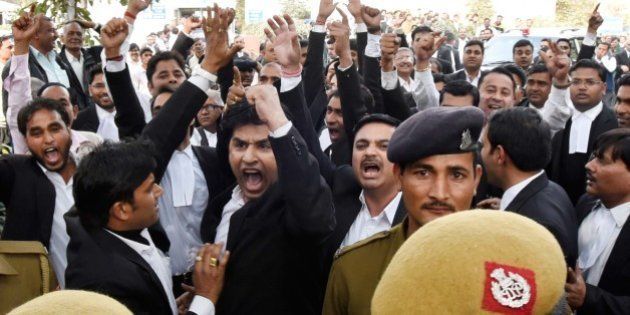NEW DELHI, INDIA - FEBRUARY 15: A group of lawyers allegedly thrashed protesters and journalists inside the Patiala House Court premises on Monday afternoon, on February 15, 2016 in New Delhi, India. The students and journalists had gone to the court for the bail hearing of JNUSU President Kanhaiya Kumar, who has been arrested on charges of sedition for allegedly raising anti-India slogans. The escalating stand-off over the arrest of Kanhaiya Kumar on sedition charges today saw the students going on strike demanding his immediate release. Scuffle broke out in Patiala House court when JNUSU President Kanhaiya Kumar was being produced. The court ruled that JNUSU President Kanhaiya Kumar will stay in custody for two more days. (Photo by Sonu Mehta/Hindustan Times via Getty Images)