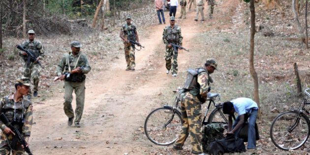 Indian paramilitary soldiers patrol during an operation under