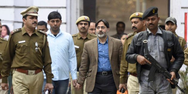 NEW DELHI, INDIA - FEBRUARY 16: Delhi Police officers arrest SAR Geelani (Syed Abdul Rahman Geelani), former Delhi University lecturer, in connection with the sedition charges for allegedly organising an event at the Press Club of India to mark Parliament attack convict Afzal Guru's death anniversary, at Parliament Street Police Station on February 16, 2016 in New Delhi, India. Geelani was detained by police on Monday evening. Geelani had faced trial as Guru's co-accused in the Parliament attack case but was acquitted by the Delhi High Court, a ruling that was later upheld by the Supreme Court. Mr. Geelani, who was acquitted in the 2001 Parliament attack case, was roughed up allegedly by ABVP members on the Jawaharlal Nehru University campus on Wednesday night. Mr. Geelani had arrived there to deliver a talk on Kashmir issues. (Photo by Sonu Mehta/Hindustan Times via Getty Images)
