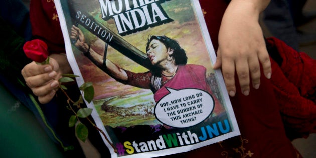 An Indian student carries a flower and holds a poster during a protest at the Jawaharlal Nehru University...