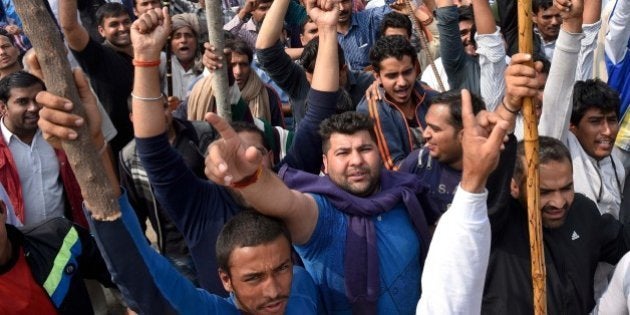 BAHADURGARH, INDIA - FEBRUARY 20: Jat community members protest demanding reservation in government services on February 20, 2016 in Bahadurgarh, India. A mob of around 10,000 people carrying weapons from the surrounding villages of Rohtak were also seen vandalising private property. Police and army have not been able to reach the area as yet. At least one person was killed and 20 others were injured on Saturday in Haryana's Jhajjar after Indian Army personnel fired on Jat protestors, demanding reservation in jobs and education, turned violent and tried to set government buildings on fire. Jat leaders rejected the offer made by the state government and said that the stir would continue till their demand is met. (Photo by Ravi Choudhary/Hindustan Times via Getty Images)