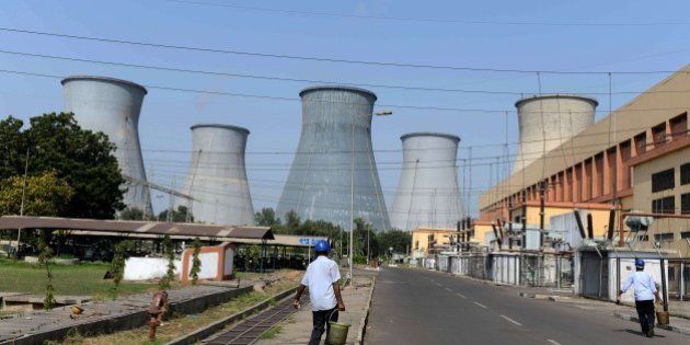 Indian workers walk on the campus of the Wanakbori thermal power plant at Wanakbori village, some 120 kms from Ahmedabad on October 15, 2015. Gujarat state Chief Minister Anandiben Patel laid the foundation stone for an 800 mega watt (MW) super critical coal-based thermal power plant, to be set up by the Bharat Heavy Electricals Limited (BHEL) at Wanakbori in Kheda district of Gujarat state. AFP PHOTO / Sam PANTHAKY (Photo credit should read SAM PANTHAKY/AFP/Getty Images)