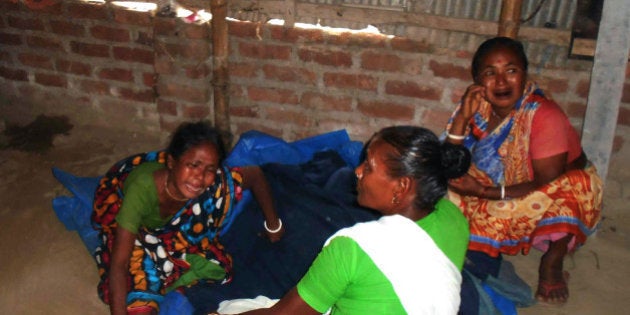 Bangladeshi relatives of a top Hindu priest react after he was killed in the remote northern district of Panchagarh on February 21, 2016. Unknown assailants slaughtered a top Hindu priest in Bangladesh's remote northern district on February 21 and injured two other devotees in a latest attack targetting minorities in the Muslim-majority nation. AFP PHOTO / AFP / STR (Photo credit should read STR/AFP/Getty Images)