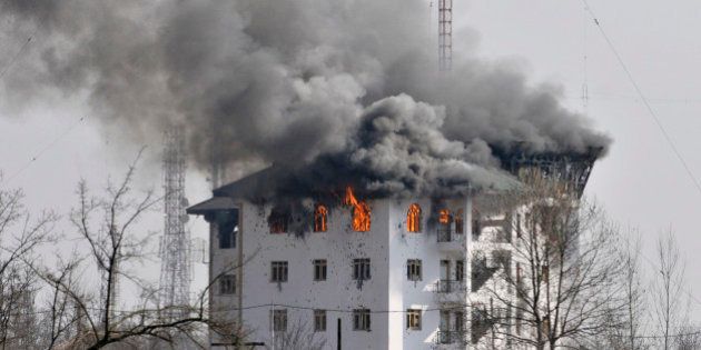 SRINAGAR, INDIA - FEBRUARY 22: Columns of smoke come out from the top floor of Entrepreneurship Development Institute building in which militants were holed up during a gunfight on February 22, 2016 in Sempora, Pampore on the outskirts of Srinagar, India. Three militants barged into the institute building on Saturday soon after attacking a convoy of security forces, leaving three CRPF jawans dead and eight injured. One civilian, Abdul Gani Mir died after sustaining a bullet injury later. (Photo by Waseem Andrabi/Hindustan Times via Getty Images)