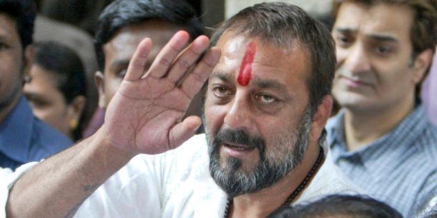 Bollywood actor Sanjay Dutt waves as he arrives at his residence in Mumbai, India, Thursday, Nov. 29, 2007. Bollywood star Sanjay Dutt was released from prison Thursday after India's top court granted him bail pending an appeal against his conviction for possessing illegal weapons, an official said. (AP Photo/Gautam Singh)