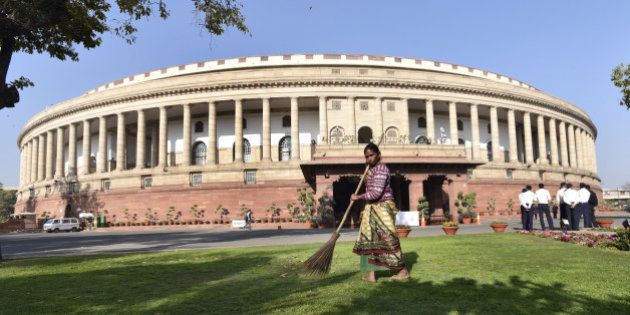 NEW DELHI, INDIA - FEBRUARY 23: A Lady cleans compound of Parliament House on the first day of the Budget Session on February 23, 2016 in New Delhi, India. (Photo by Arvind Yadav/Hindustan Times via Getty Images)