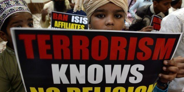 Indian Muslim students hold posters during a gathering to denounce the Islamic State, in Mumbai on November 20, 2015. Islamic State jihadists claimed a series of coordinated attacks by gunmen and suicide bombers in Paris on November 13, that killed at least 129 people in scenes of carnage at a concert hall, restaurants and the national stadium. AFP PHOTO/ Indranil MUKHERJEE (Photo credit should read INDRANIL MUKHERJEE/AFP/Getty Images)