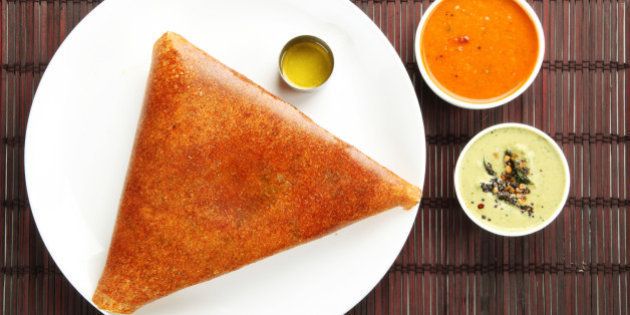 Masala dosa with different types of chutney and sambar. This is a closeup shot of one of the most famous indian snack.