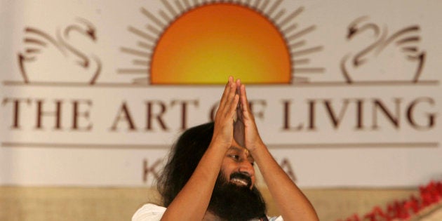 Indian spiritual guru and founder of The Art of Living Foundation Sri Sri Ravi Shankar greets followers as he arrives at a meditation camp in Calcutta, India, Saturday, Feb. 14, 2009. (AP Photo/Bikas Das)