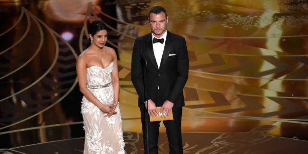 Priyanka Chopra, left, and Liev Schreiber present the award for best film editing at the Oscars on Sunday, Feb. 28, 2016, at the Dolby Theatre in Los Angeles. (Photo by Chris Pizzello/Invision/AP)