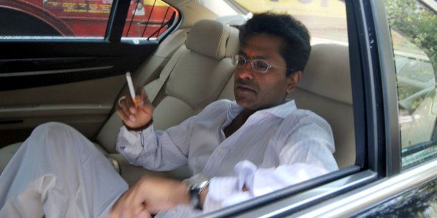 Indian Premier League chief Lalit Modi smokes a cigarette inside his car on his way to meet Mukesh Ambani, a top industrialist and owner of the IPL team Mumbai Indians, in Mumbai, India, Thursday, April 22, 2010. Income tax officials questioned beleaguered Modi over corruption allegations surrounding a new franchise for a second successive day Thursday, while tax sleuths searched offices of various team franchises that feature in the immensely successful Twenty20 league. (AP Photo)