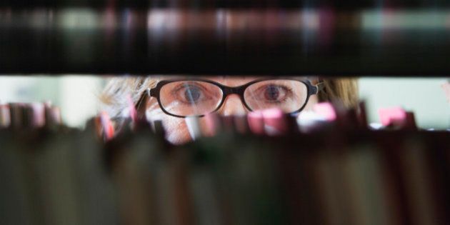 Woman with Eyeglasses Behind File Cabinet