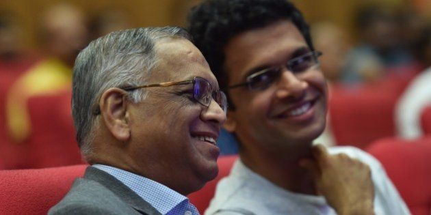 Infosys co-founder Narayana Murthy (L) and his son Rohan Murthy watch the proceedings during the company's 34th Annual General Meeting of the company in Bangalore on June 22, 2015. AFP PHOTO (Photo credit should read STR/AFP/Getty Images)