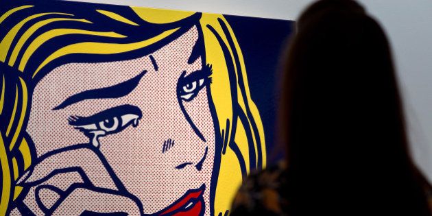 LONDON, ENGLAND - OCTOBER 09: A guest views 'Crying Girl' by artist Roy Lichtenstein during the preview ahead of the artist's muse: a curated evening sale at Christie's New York on October 9, 2015 in London, England. The impressionist, modern, post-war and contemporary works will be on show to the public between October 10 and October 17 and includes Amedeo Modigliani's 'Nu couche' which is estimated to sell for 100 USD million. The sale also showcases pieces by artists including Lucian Freud, Paul Cezanne, Peter Doig, Pablo Picasso, Alberto Giacometti, Amedeo Modigliani and Roy Lichtenstein. (Photo by Ben Pruchnie/Getty Images)