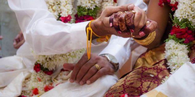 This moment is captured during the rituals process in a Indian Hindu wedding.