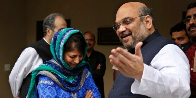 India's ruling Bharatiya Janata Party (BJP) president Amit Shah, right, gestures to the media after a meeting with Kashmirâs regional Peoples' Democratic Party (PDP) leader Mehbooba Mufti, left in blue, in New Delhi, India, Tuesday, Feb. 24, 2015. The BJP and the PDP Tuesday finalized an agreement to form a coalition government in Kashmir, the first time the Hindu nationalist party will share a leadership position in the predominantly Muslim region. (AP Photo / Manish Swarup)
