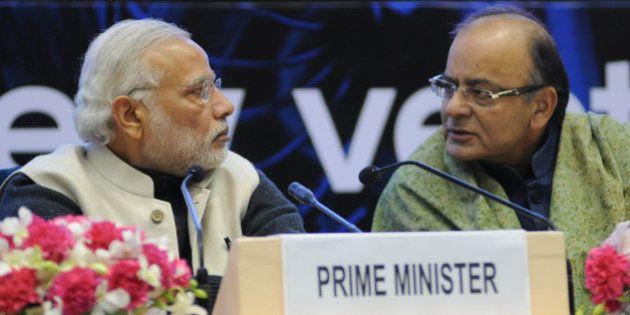 Indian Prime Minister Narendra Modi (L) and Finance Minister Arun Jaitley talk during an event to launch an initiative to bolster start-ups in New Delhi on January 16, 2016. Indian entrepreneurs will receive generous tax breaks and face dramatically reduced red tape when starting and closing a business, Prime Minister Narendra Modi said January 16, as he launched a pet initiative to bolster India's fast-growing startup scene. Speaking at a gathering of 2,000 entrepreneurs from India, Silicon Valley and elsewhere, Modi outlined a slew of measures under Start Up India including exempting startups from income tax for their first three years. AFP PHOTO / STR / AFP / STRDEL (Photo credit should read STRDEL/AFP/Getty Images)