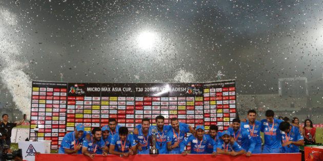 Indian players pose with the trophy after winning the Asia Cup Twenty20 international cricket final match against Bangladesh in Dhaka, Bangladesh, Sunday, March 6, 2016. India won the Asia Cup for the sixth time after beating host Bangladesh by eight wickets on Sunday.(AP Photo/ A.M. Ahad)