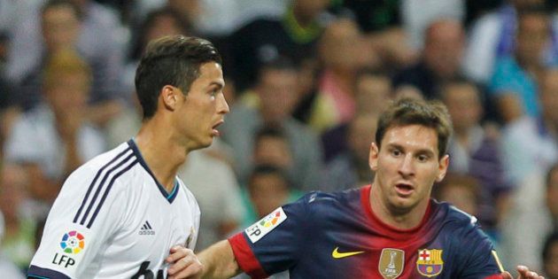 Real Madrid's Cristiano Ronaldo from Portugal, left, vies for the ball with FC BarcelonaÂ´s Lionel Messi from Argentina, right, during a Spanish Supercup second leg soccer match at the Santiago Bernabeu stadium in Madrid, Spain, Wednesday, Aug. 29, 2012. (AP Photo/Andres Kudacki)