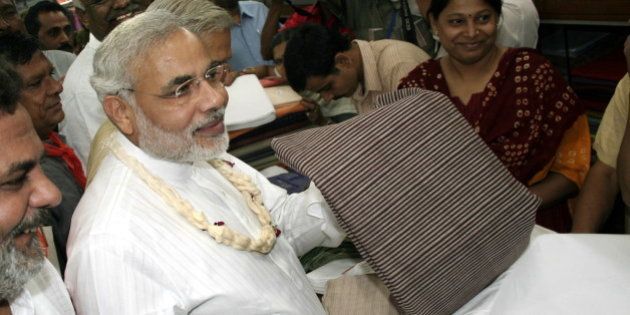 INDIA - NOVEMBER 04: Narendra Modi, Chief Minister of Gujarat purchasing the Khadi in Ahmedabad Khadi Bhandar in Gujarat, India (Photo by Shailesh Raval/The India Today Group/Getty Images)