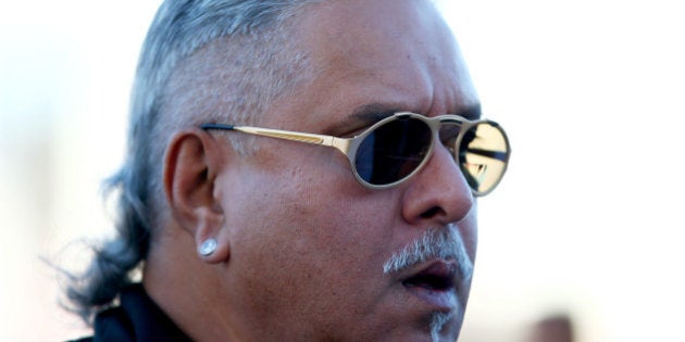 AUSTIN, TX - OCTOBER 31: Force India Chairman Vijay Mallya walks along the paddock during practice ahead of the United States Formula One Grand Prix at Circuit of The Americas on October 31, 2014 in Austin, United States. (Photo by Mark Thompson/Getty Images)