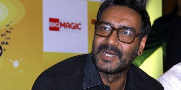 Indian Bollywood film actor, Ajay Devgn, as a brand ambassador for Hajmola Chatpata No.1, poses during a promotional event in Mumbai on February 26, 2015. AFP PHOTO (Photo credit should read STR/AFP/Getty Images)